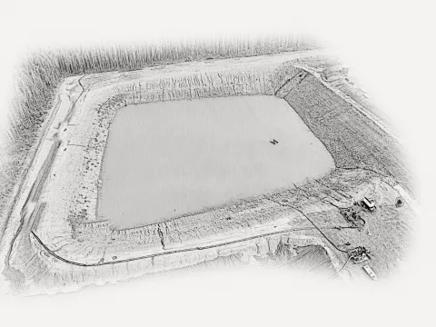 Aerial view of an industrial containment pond surrounded by earthen berms, access roads, and forested land.
